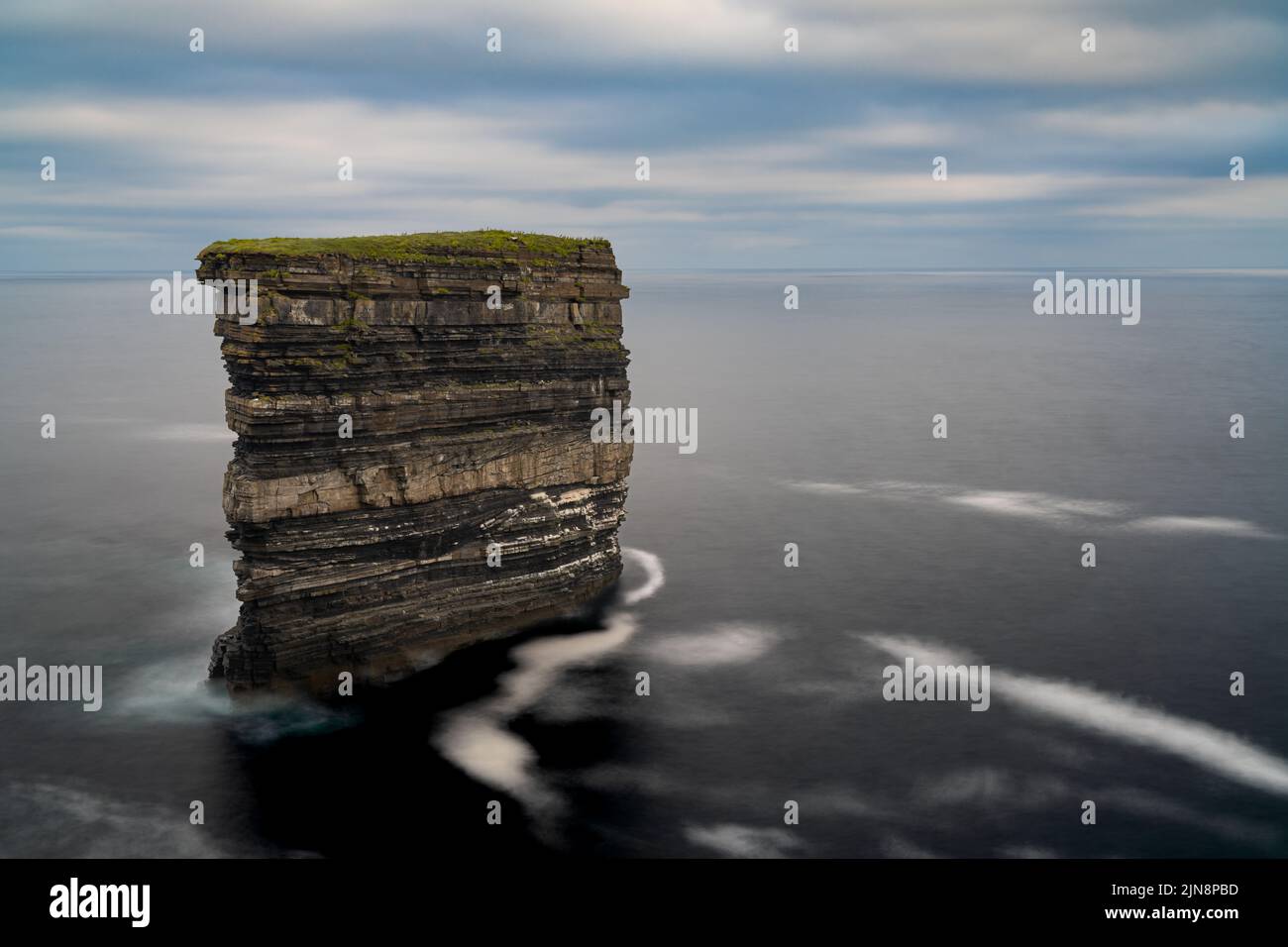 A long exposure view of the landmark sea stack Downpatrick Head in County Mayo of Ireland Stock Photo