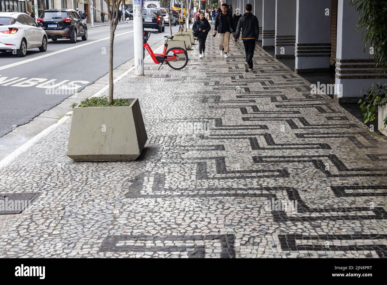 A Portuguese sidewalk pavement with people in Paulista Avenue Stock Photo