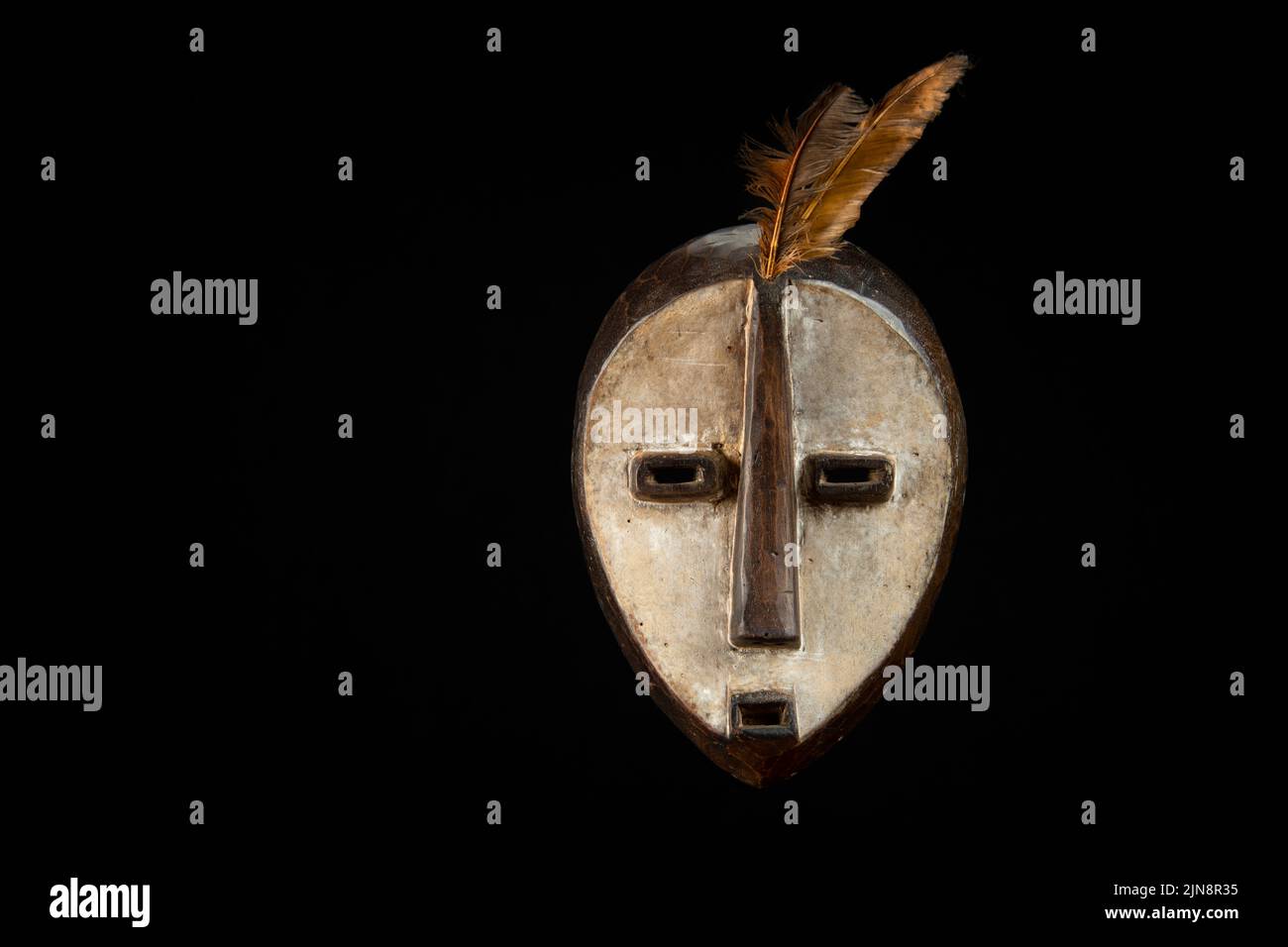 Traditional Gabonse wooden mask on a black background Stock Photo - Alamy