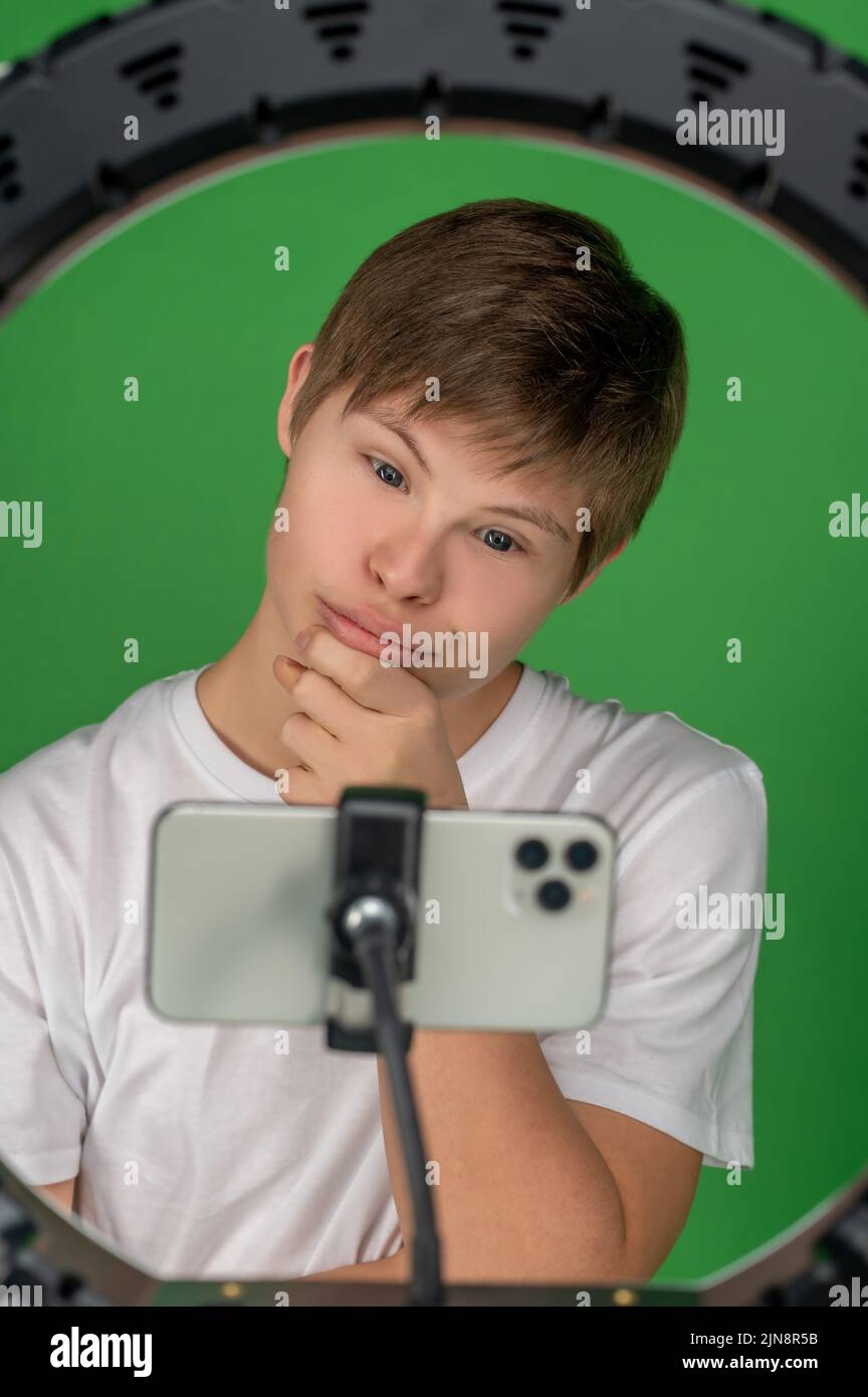Modern boy taking selfies with a ring light Stock Photo