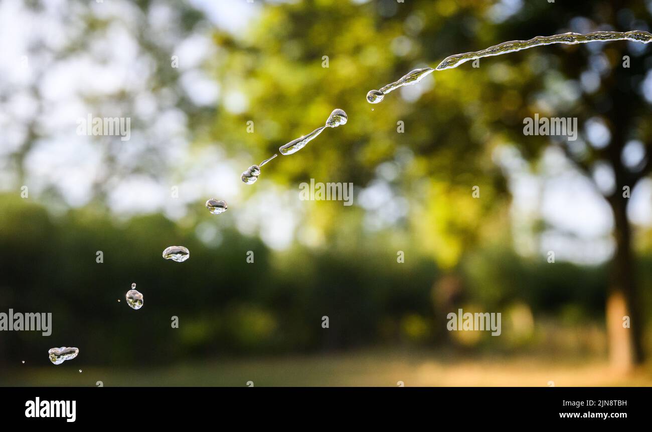 Hanover, Germany. 10th Aug, 2022. Water splashes from a public drinking