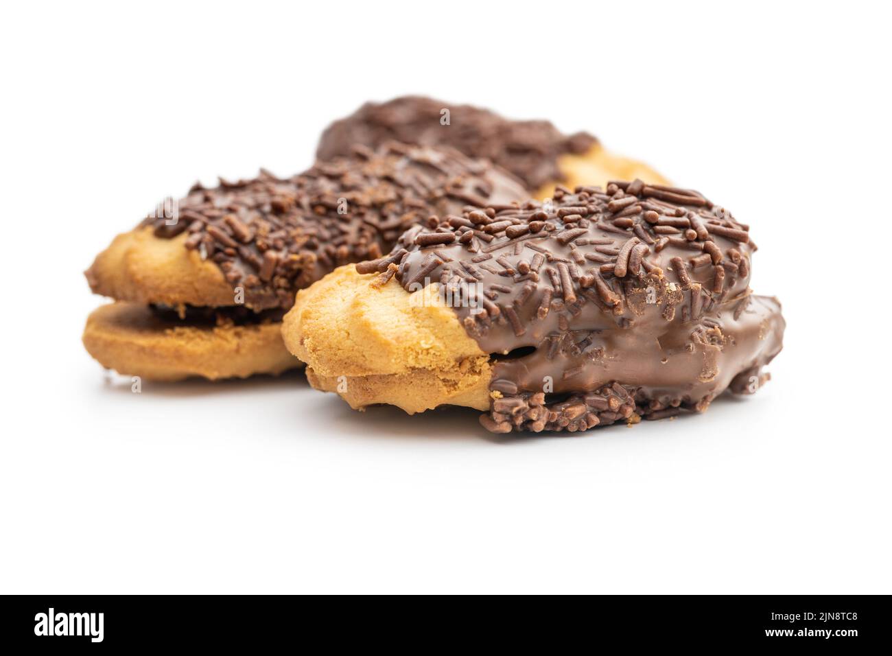 Petit fours with chocolate sprinkles. Mini chocolate dessert isolated on white background. Stock Photo