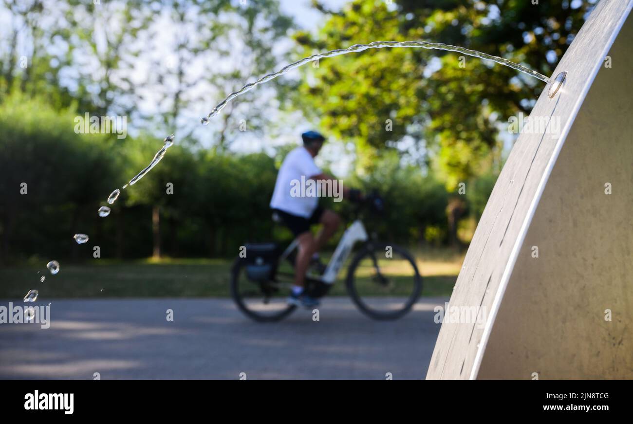 Hanover, Germany. 10th Aug, 2022. Water splashes from a public drinking