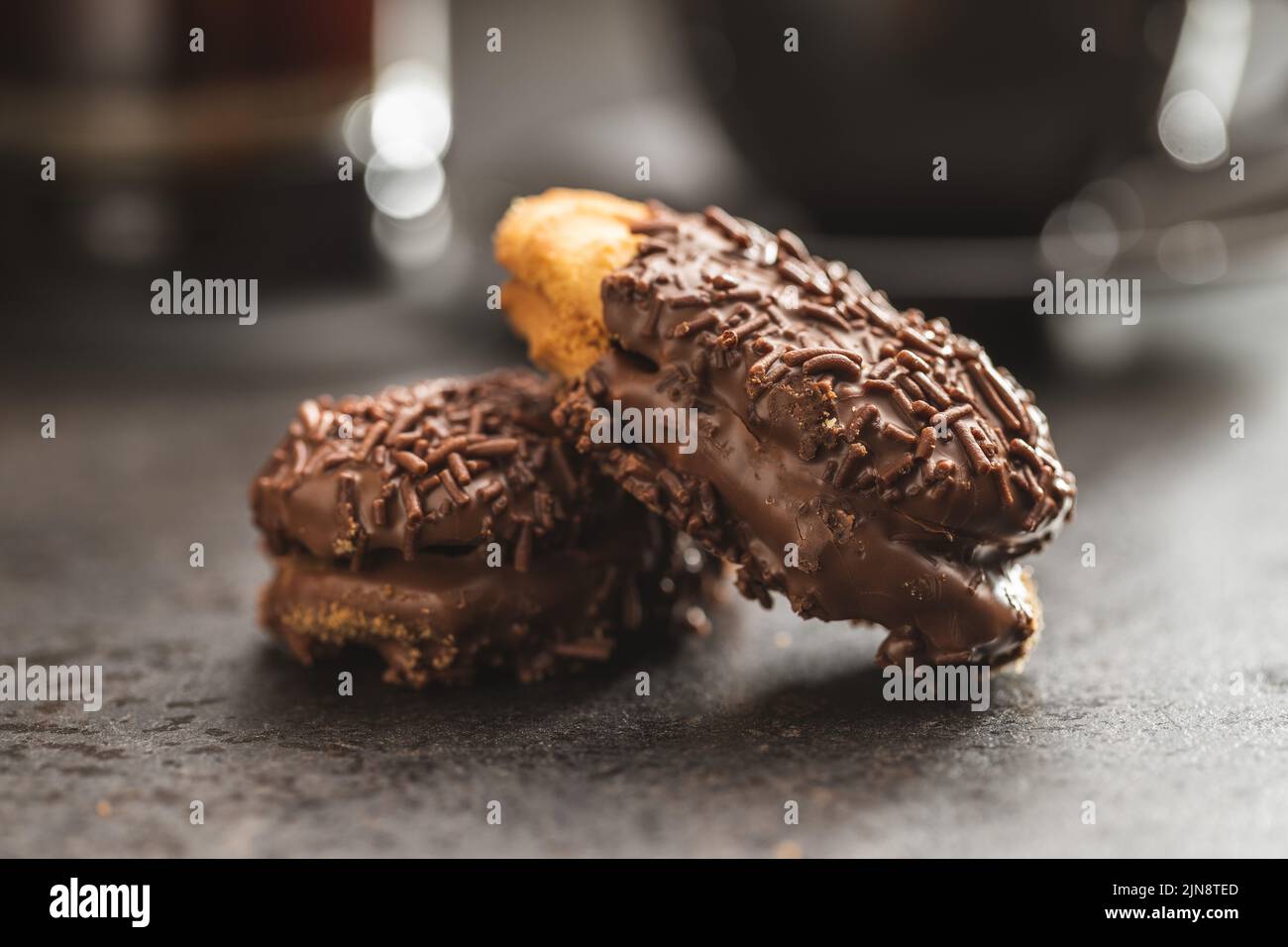 Petit fours with chocolate sprinkles. Mini chocolate dessert. Stock Photo