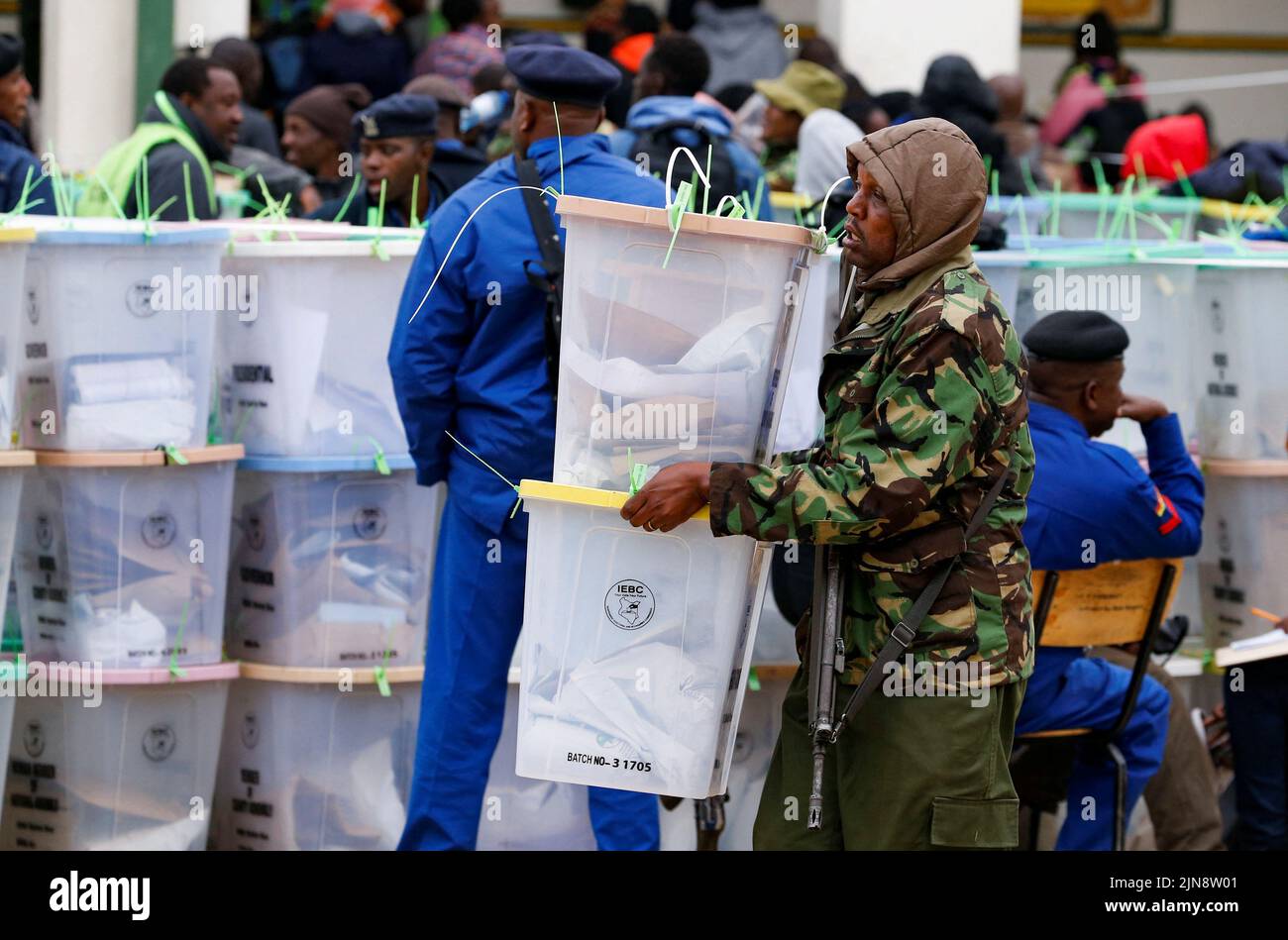 A police officer carries sealed ballot boxes containing electoral materials at an Independent Electoral and Boundaries Commission (IEBC) tallying centre after the general election in Nairobi, Kenya August 10, 2022. REUTERS/Thomas Mukoya Stock Photo