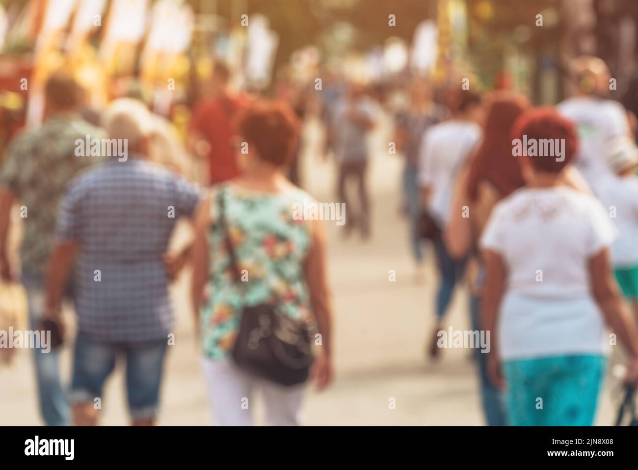 Blurred pedestrian walking down the city street, unrecognizable crowd of people in bokeh for census or citizenship concept Stock Photo