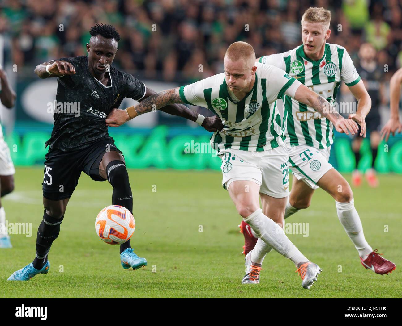 Mats Knoester of Ferencvarosi TC competes for the ball with