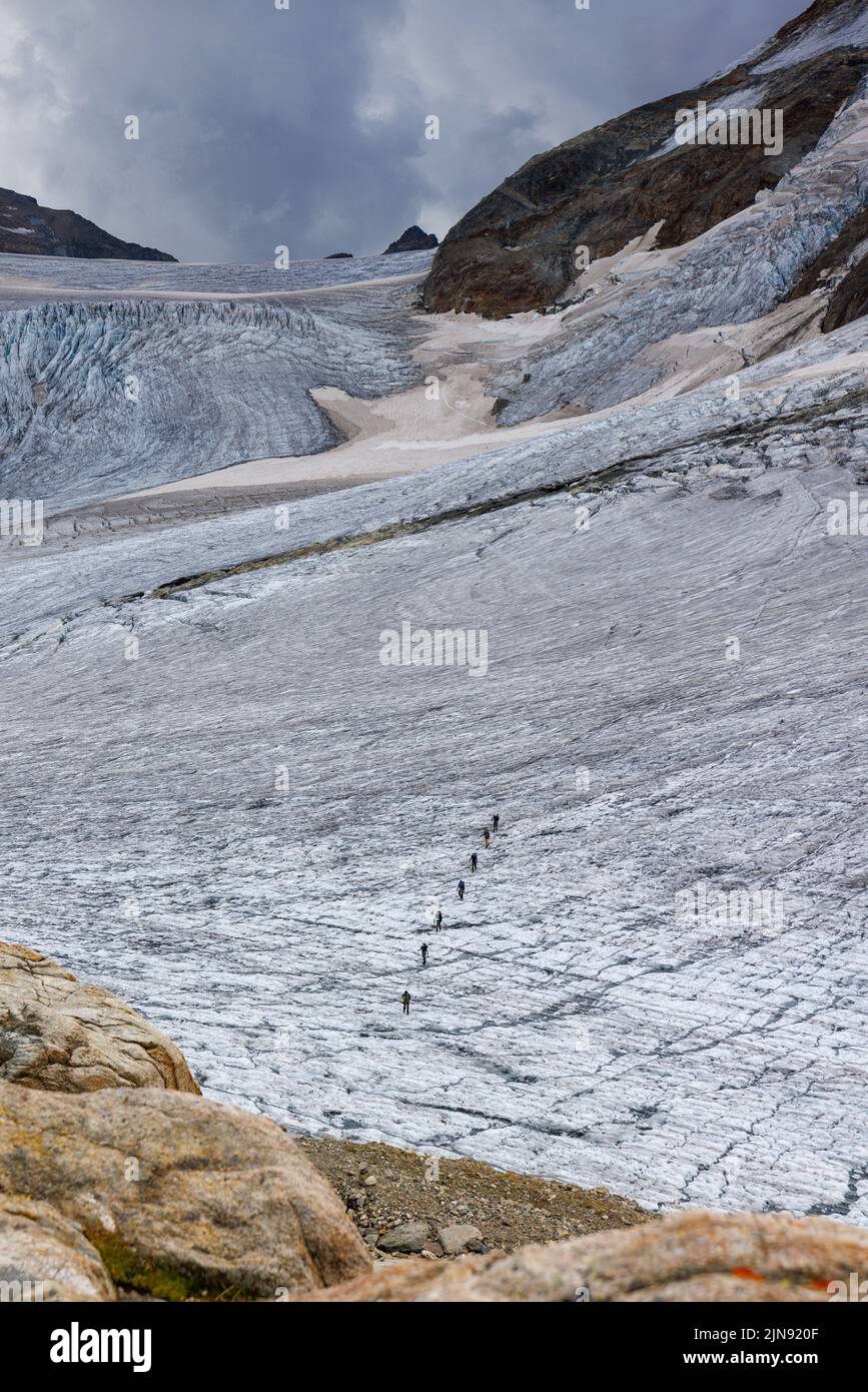 group of alpinists on glacier in the Bernese Alps Stock Photo