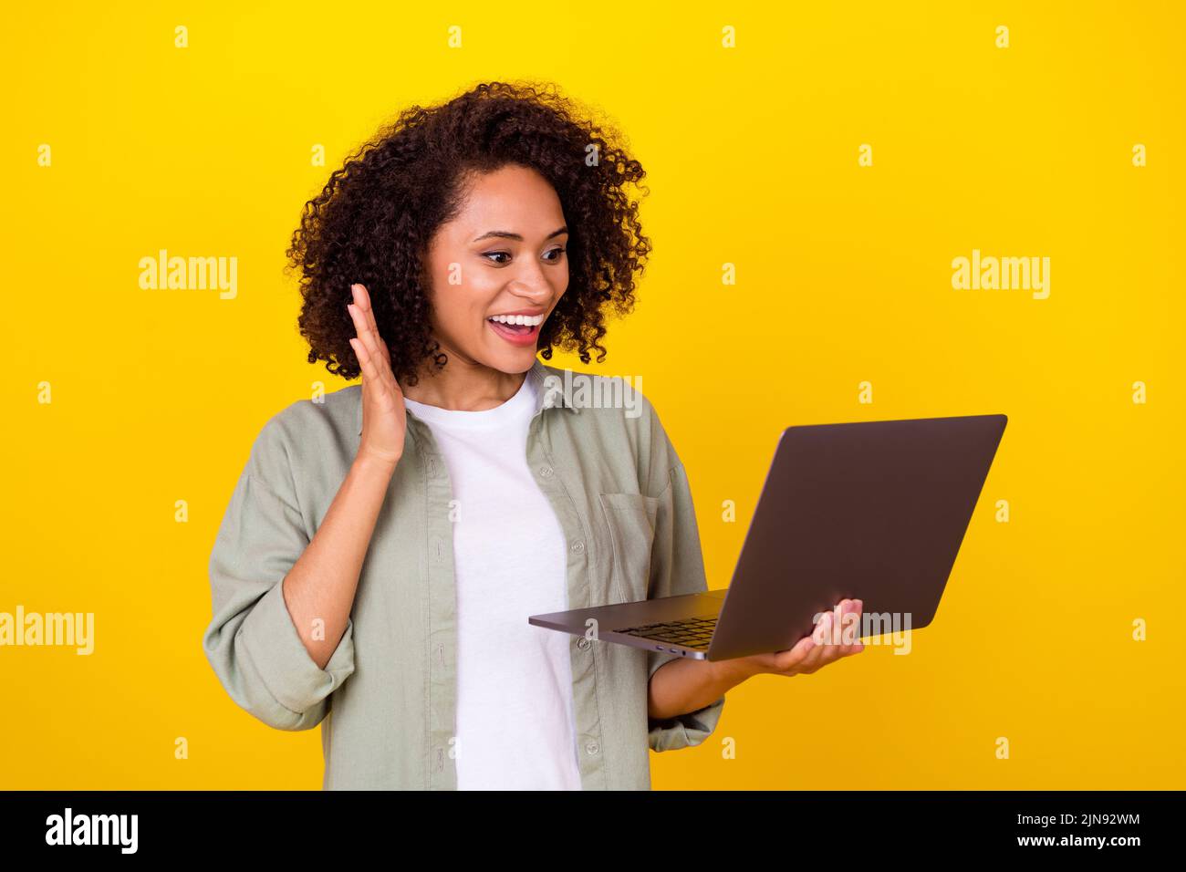 Photo Of Impressed Millennial Brunette Lady Talk Laptop Wear Grey Shirt