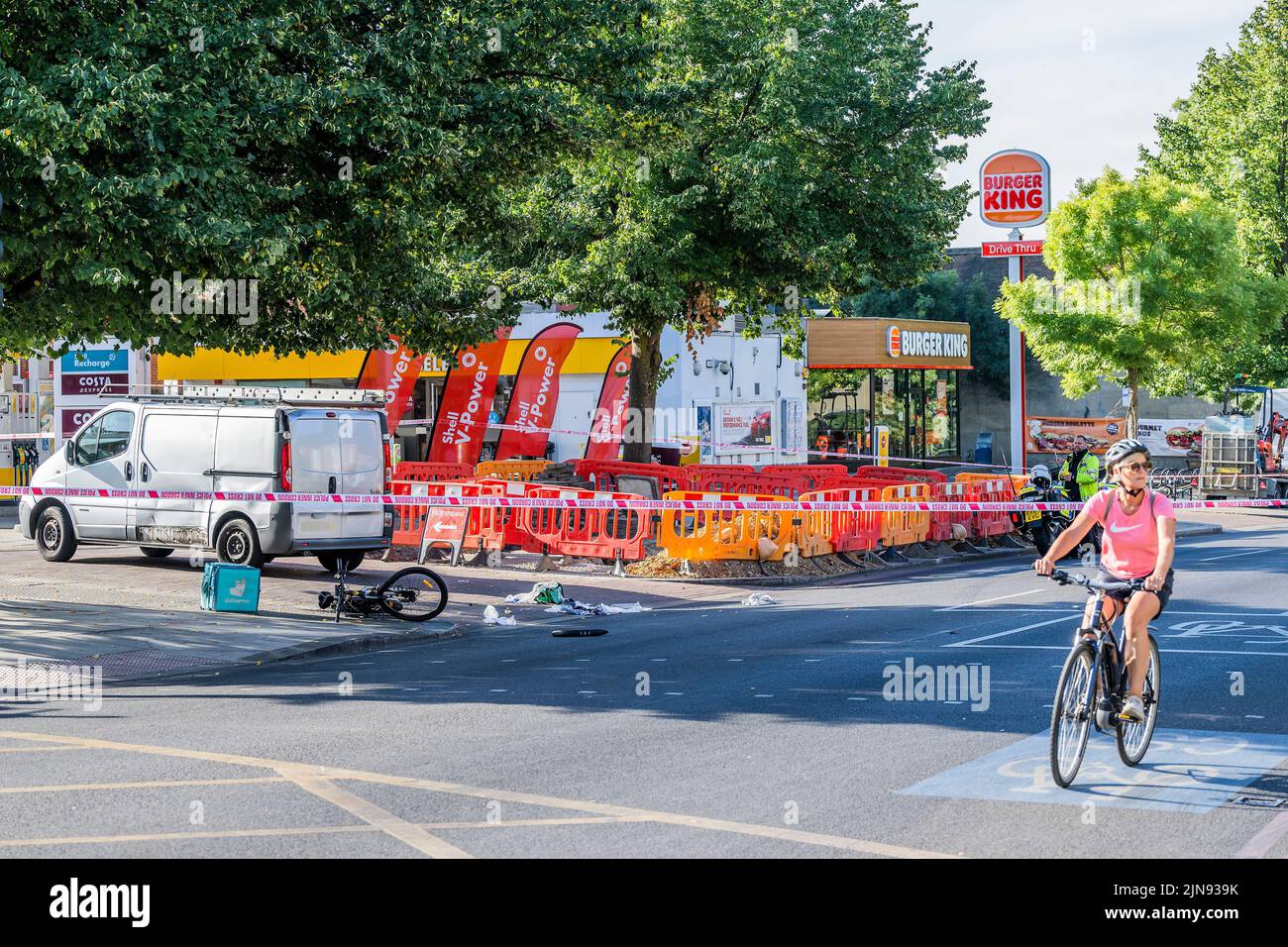 London, UK. 10th Aug, 2022. Police block Balham Hill after a deliveroo rider hits a van outside the Shell petrol station. According to a witness the rider was not wearing a helmet and suffered a head injury. Credit: Guy Bell/Alamy Live News Stock Photo