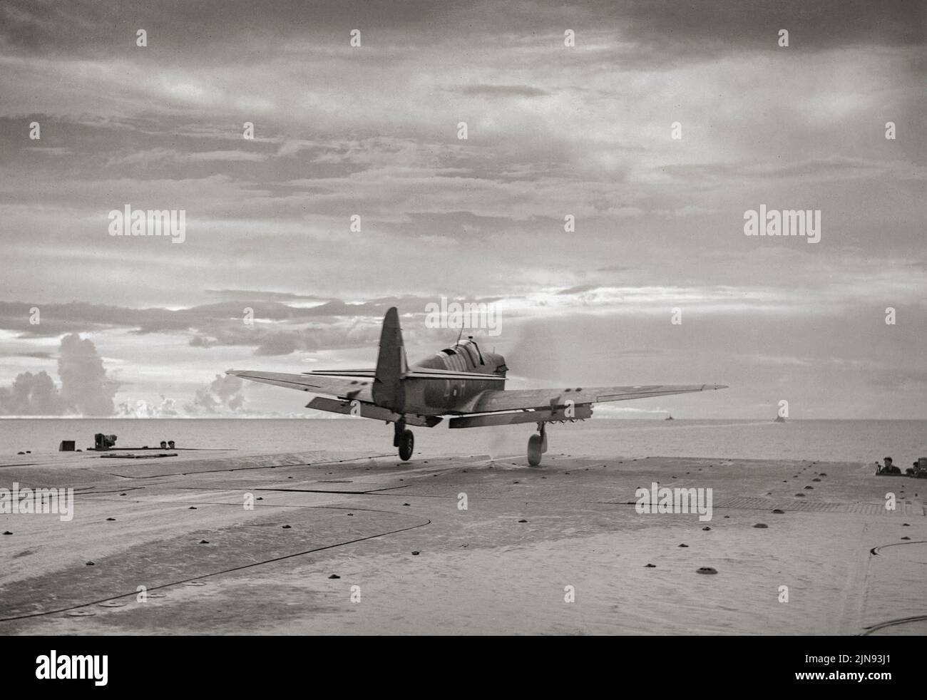 The first Fairey Firefly of 1770 Squadron, Fleet Air Arm with rockets attached, taking off from the flight deck of HMS Indefatigable during the carrier-borne air strike on the Japanese oil refinery at Pangkalan Brandan, Sumatra. The Firefly was a Second World War-era carrier-borne fighter aircraft and anti-submarine aircraft that was principally operated by the Fleet Air Arm. Stock Photo