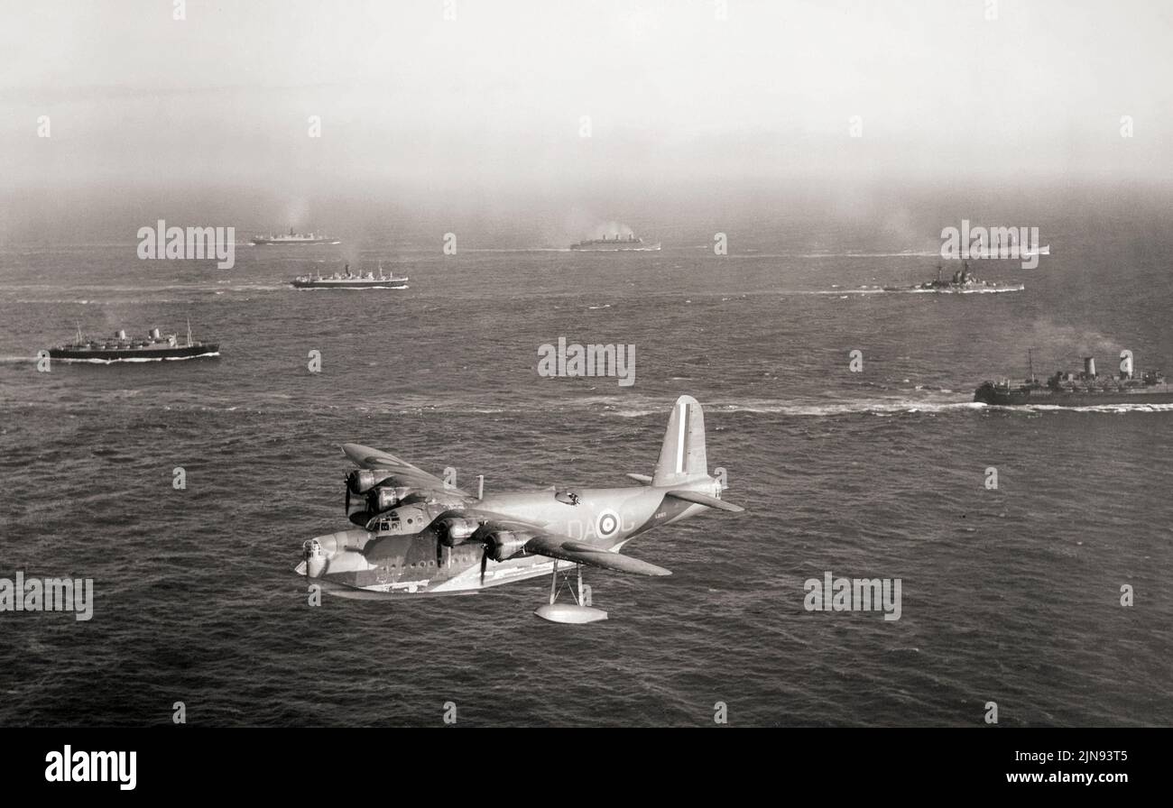 Sunderland Mark I, L2163 'DA-G', of No. 210 Squadron RAF based at Oban, Argyll, flys past Canadian Troop Convoy 6 (TC.6), while escorting it to Greenock. At the outbreak of the Second World War, 39 Sunderlands were in service with the RAF. Sunderlands quickly proved useful in the rescue of the crews from torpedoed ships and as British anti-submarine measures improved, the Sunderland began to inflict losses as well. The Germans are reputed to have nicknamed the Sunderland the 'Flying Porcupine'  due to its defensive firepower. Stock Photo