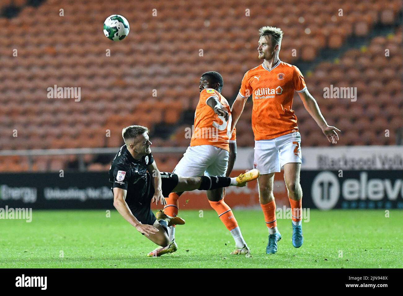 during the Carabao Cup match between Blackpool and Barrow at Bloomfield Road, Blackpool on Tuesday 9th August 2022. (Credit: Eddie Garvey | MI News)Tom White of Barrow Association Football Club is tackled by Beryly Lubala of Blackpool Football Club during the Carabao Cup match between Blackpool and Barrow at Bloomfield Road, Blackpool on Tuesday 9th August 2022. (Credit: Eddie Garvey | MI News) Credit: MI News & Sport /Alamy Live News Stock Photo