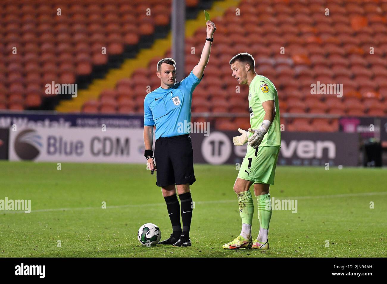 during the Carabao Cup match between Blackpool and Barrow at Bloomfield Road, Blackpool on Tuesday 9th August 2022. (Credit: Eddie Garvey | MI News)Paul Farman of Barrow Association Football Club is booked by match referee Benjamin Speedie after what he thinks was the winning penalty save during the Carabao Cup match between Blackpool and Barrow at Bloomfield Road, Blackpool on Tuesday 9th August 2022. (Credit: Eddie Garvey | MI News) Credit: MI News & Sport /Alamy Live News Stock Photo