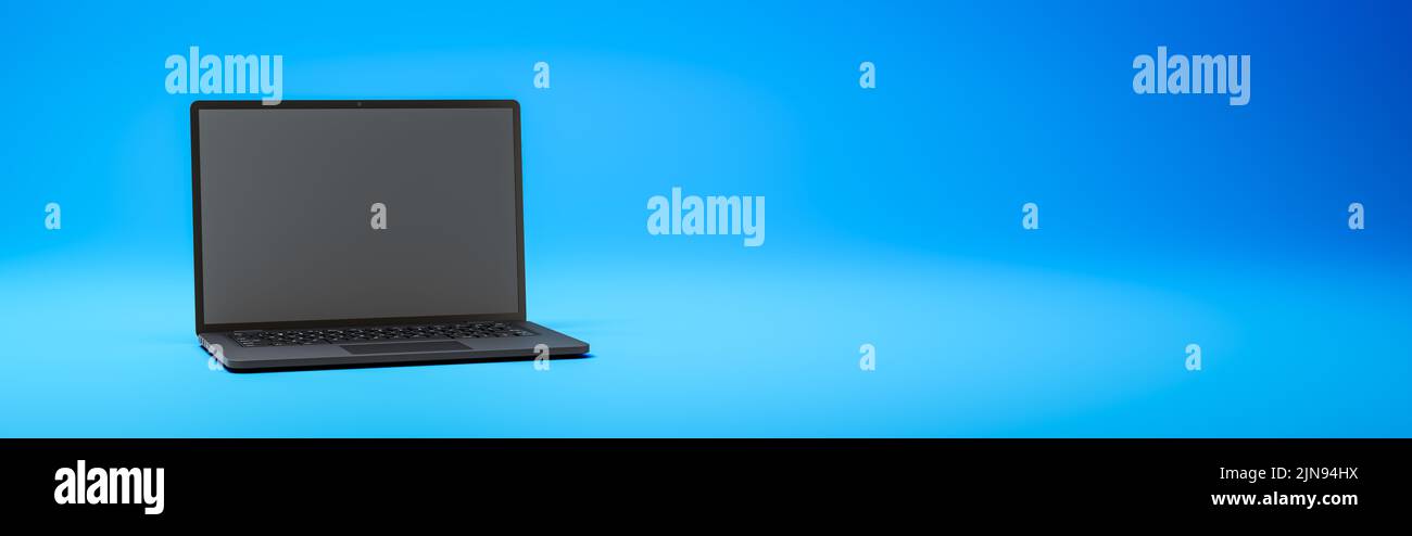 Black Laptop Computer on Blue Background with Copy Space Stock Photo