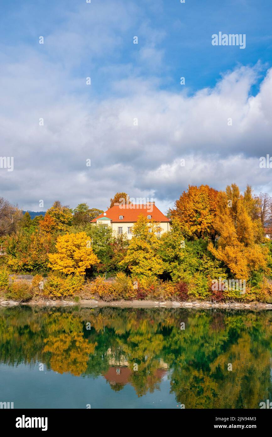 Autumn foliage on the banks of the river Drau, Villach, Austria Stock Photo