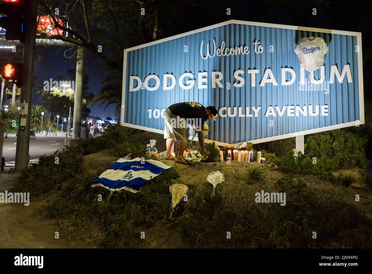 A mourner putting flowers for Vin Scully as a remembrance outside Dodger Stadium Stock Photo