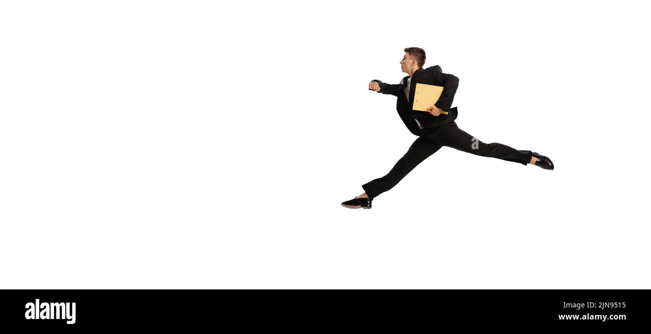 Late for work. Young office worker in business suit running isolated