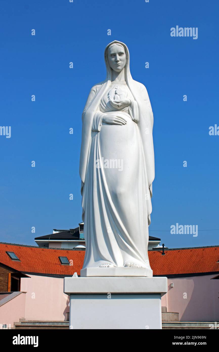 Famous landmarks, statue of the Blessed Virgin Mary in front of Holy Trinity church in Sesvete near Zagreb,Croatia Stock Photo
