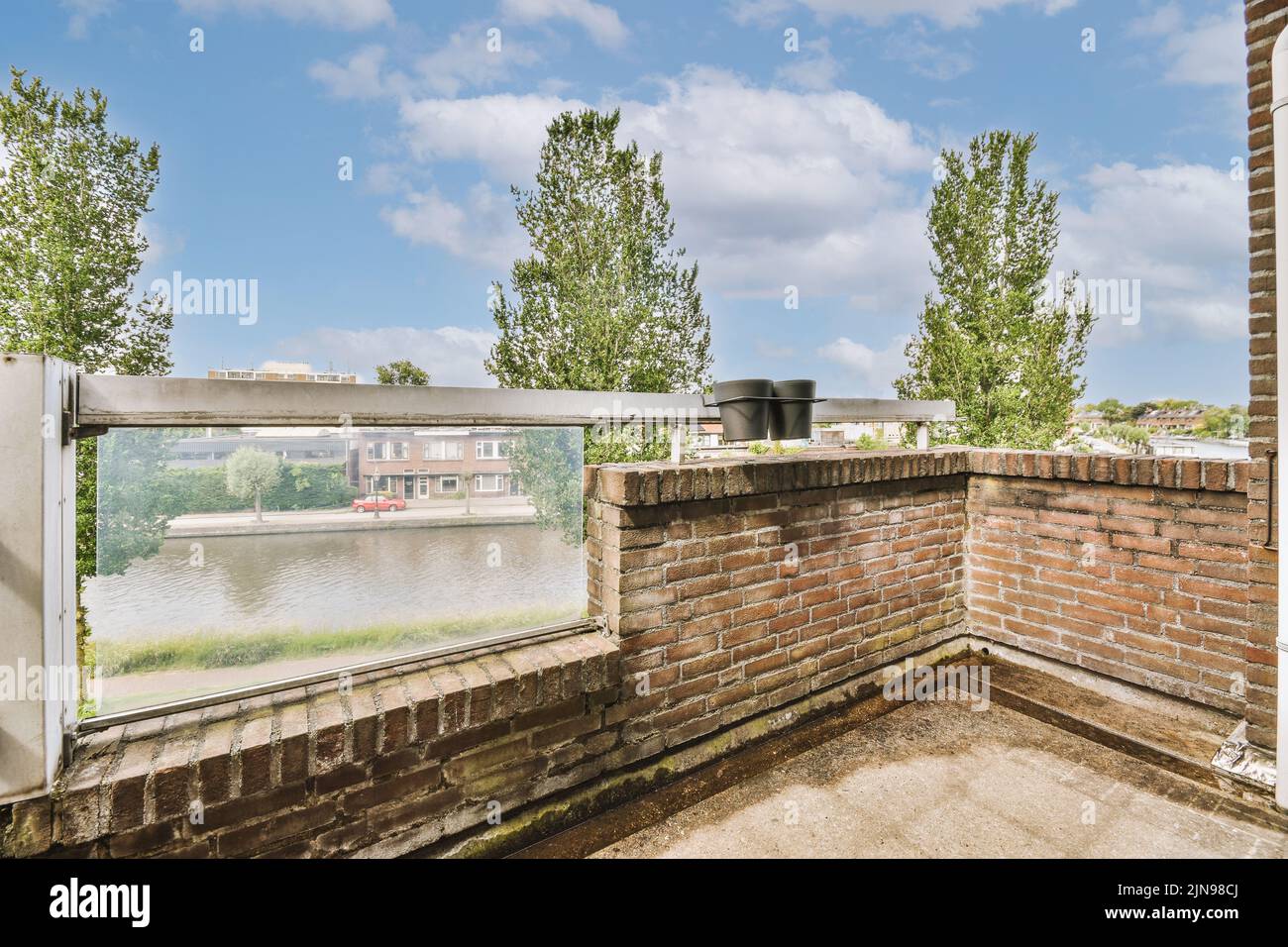 Narrow brick balcony with brick railings and door Stock Photo - Alamy