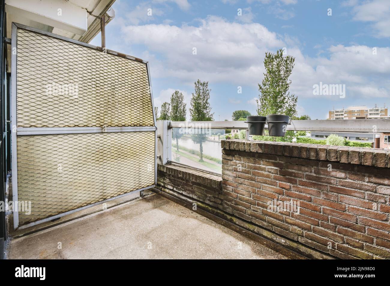 Narrow brick balcony with brick railings and door Stock Photo - Alamy