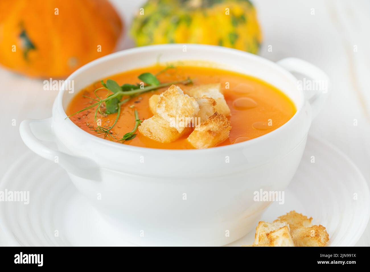 Pumpkin soup with croutons on white background. Close up Stock Photo ...