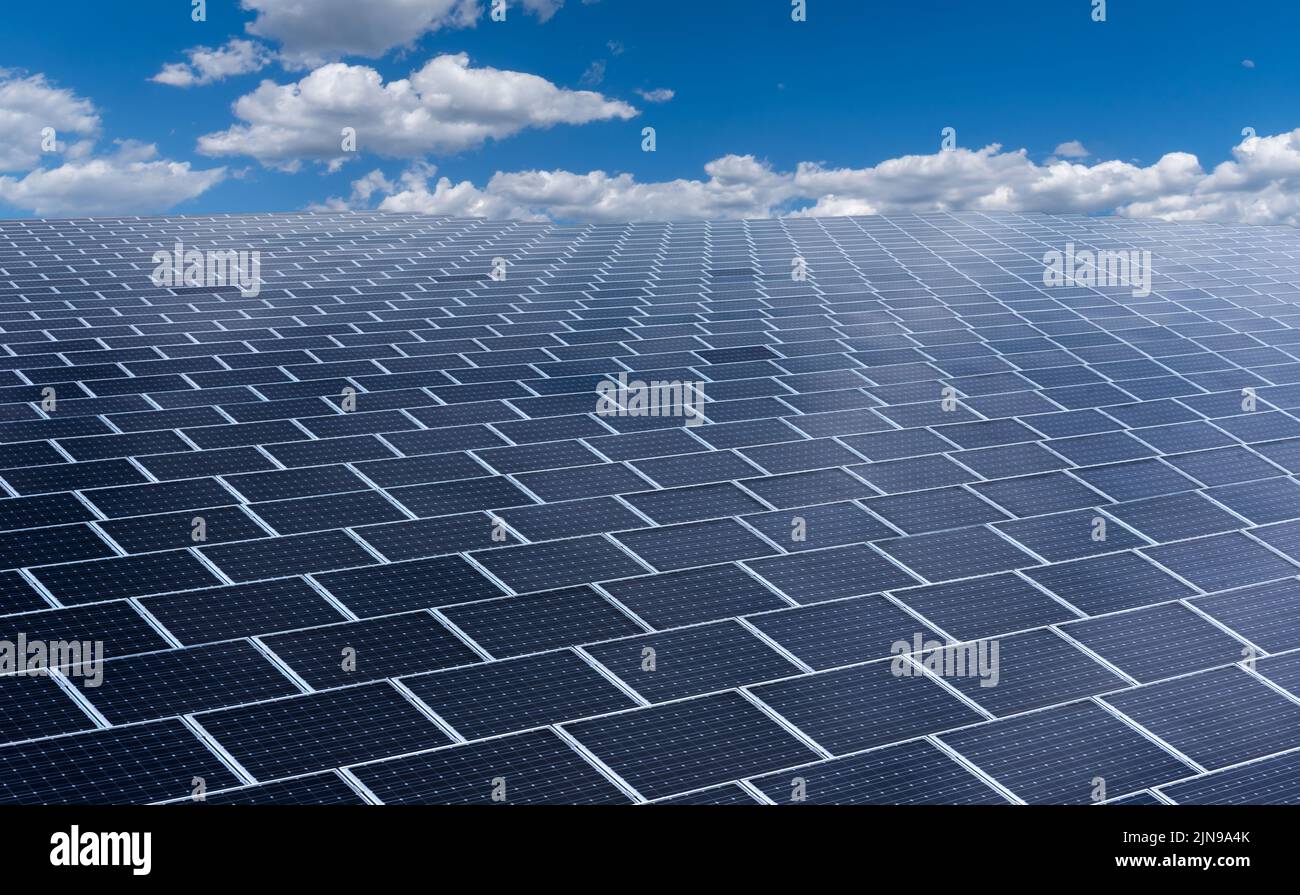 Vast surface of Solar Panels on blue sky with white clouds ...