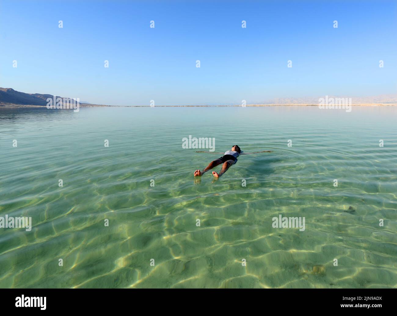 Floating on the salty water of the Dead Sea in Israel. Stock Photo