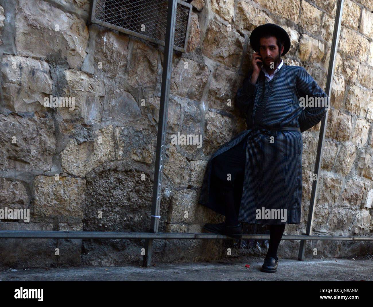 A Hassidic man using his mobile phone in Mea Shearim neighborhood in Jerusalem, Israel. Stock Photo
