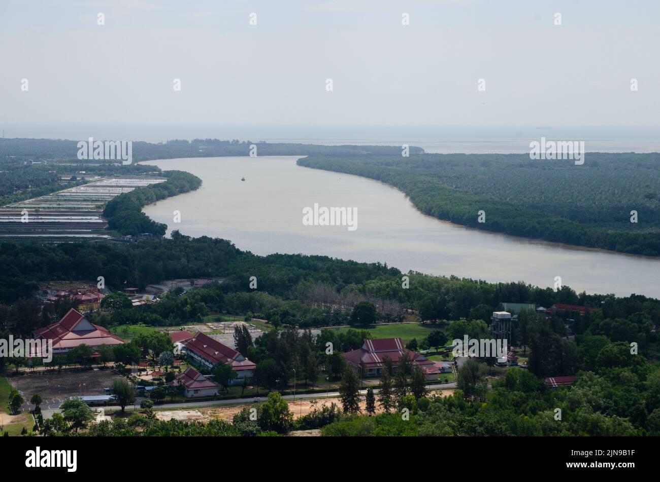 An aerial landscape of a small town in the forest at the river Stock ...