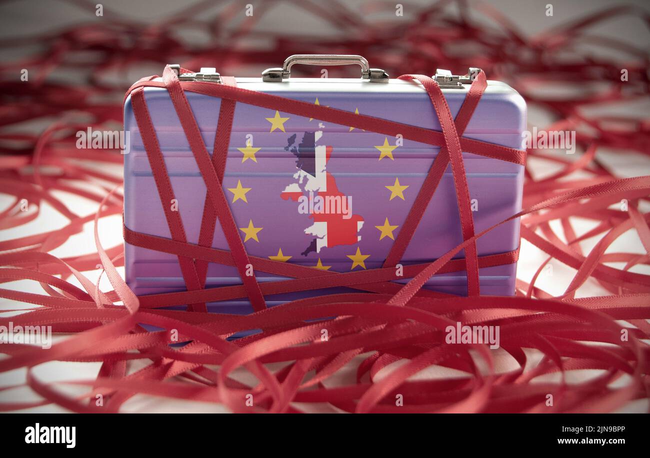 Red tape around a briefcase labeled tax Stock Photo Alamy