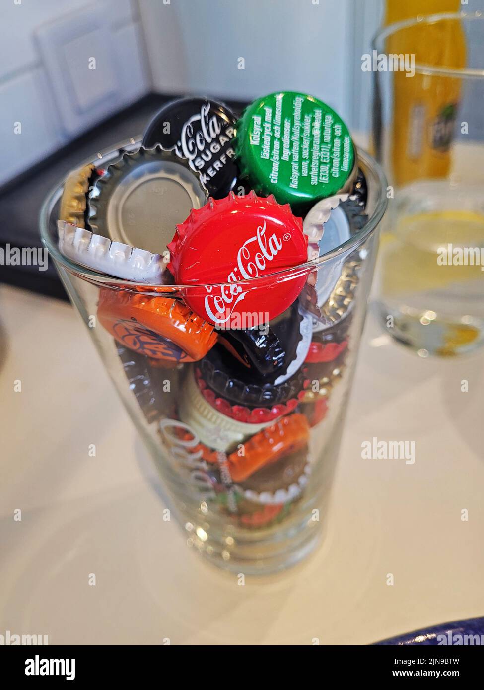 Different types of caps for soft drinks in the cash register at a