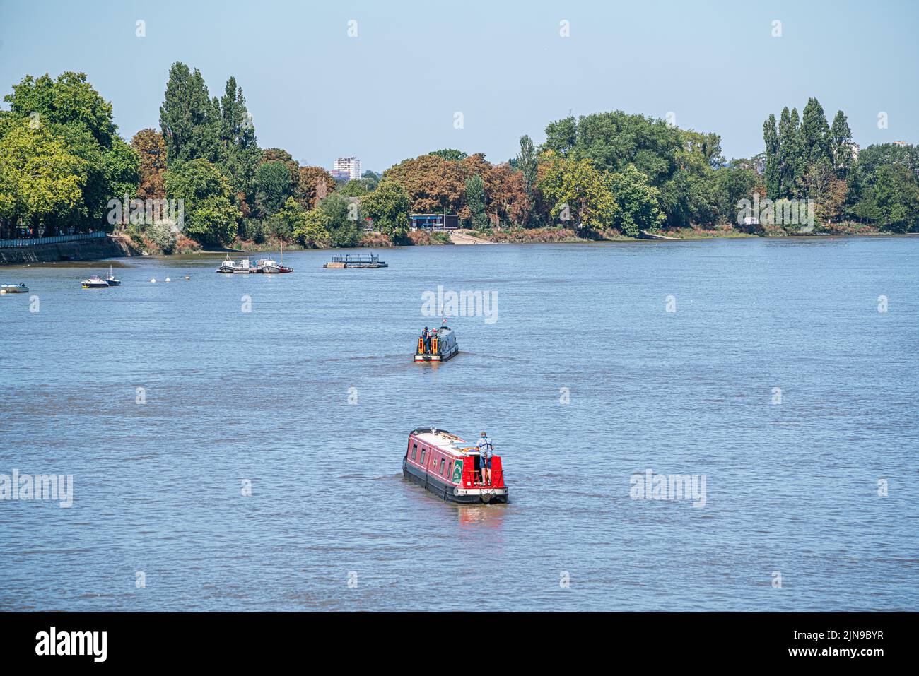 Putney London, UK. 10th Aug, 2022. Barges navigating on the Rover Thames in Putney, south west London under clear blue skies. The Met Office has issued an amber extreme heat warning for southern and central England and parts of Wales from Thursday until Sunday as temperatures are expected to reach up to 35C in some parts of the country Credit. Credit: amer ghazzal/Alamy Live News Stock Photo