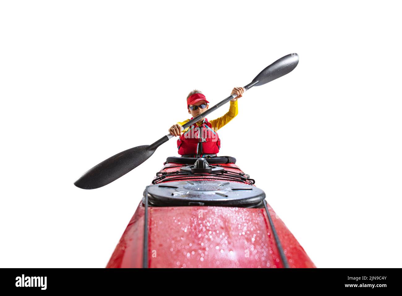 Beginner kayaker in red canoe, kayak with a life vest and a paddle