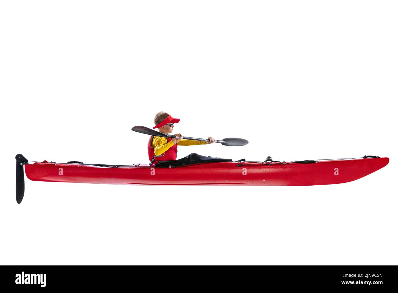 Side view. Beginner kayaker in red canoe, kayak with a life vest and a
