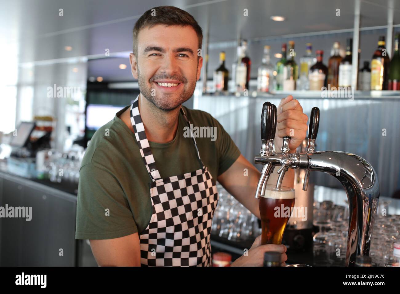 Bartender serving a refreshing looking beer Stock Photo
