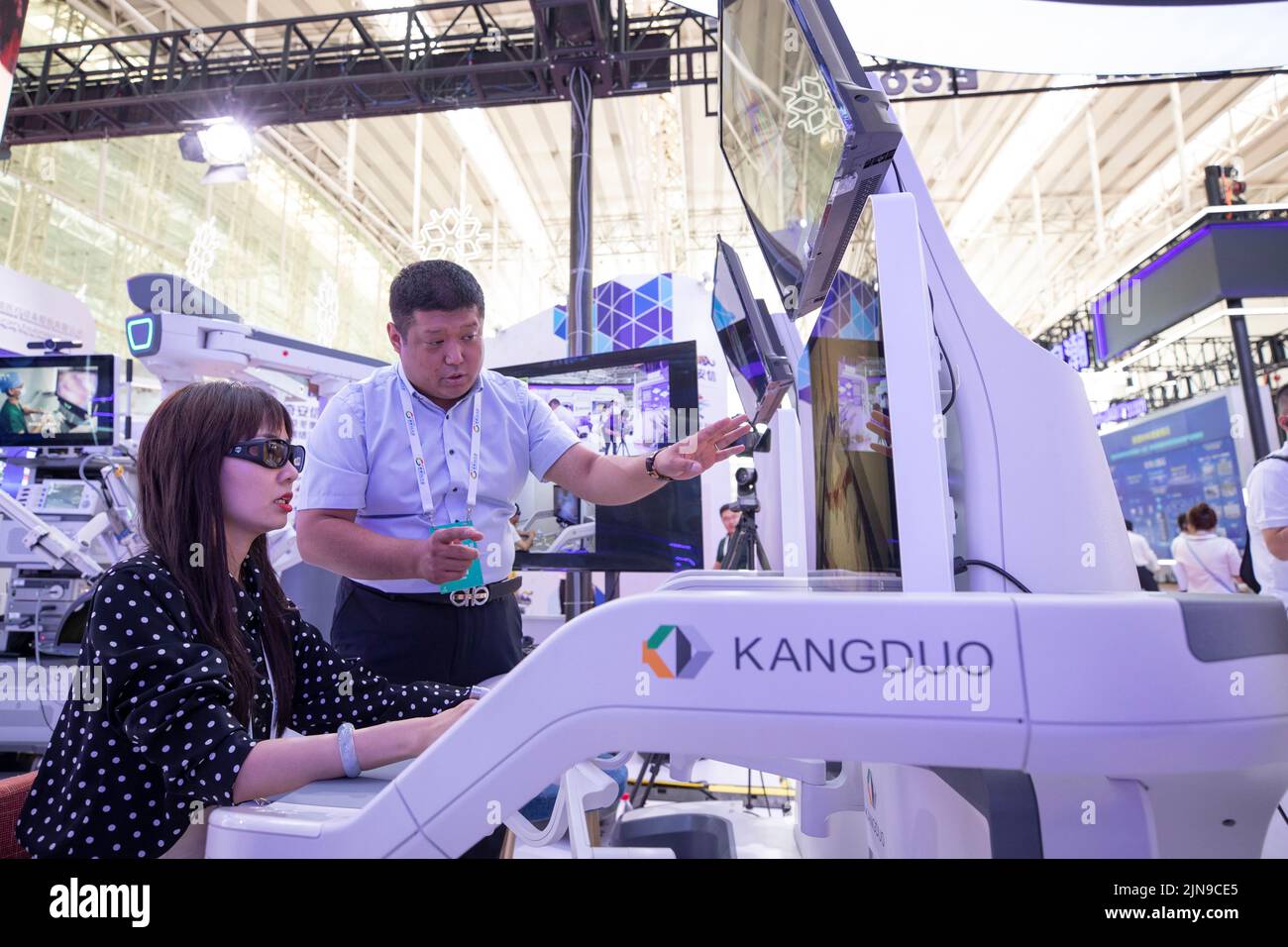 Harbin, China's Heilongjiang Province. 10th Aug, 2022. An exhibitor demonstrates the 5G remote surgery robot at an exhibition booth of the 2022 World 5G Convention in Harbin, capital of northeast China's Heilongjiang Province, Aug. 10, 2022. The 2022 World 5G Convention kicked off here on Wednesday. Credit: Zhang Tao/Xinhua/Alamy Live News Stock Photo