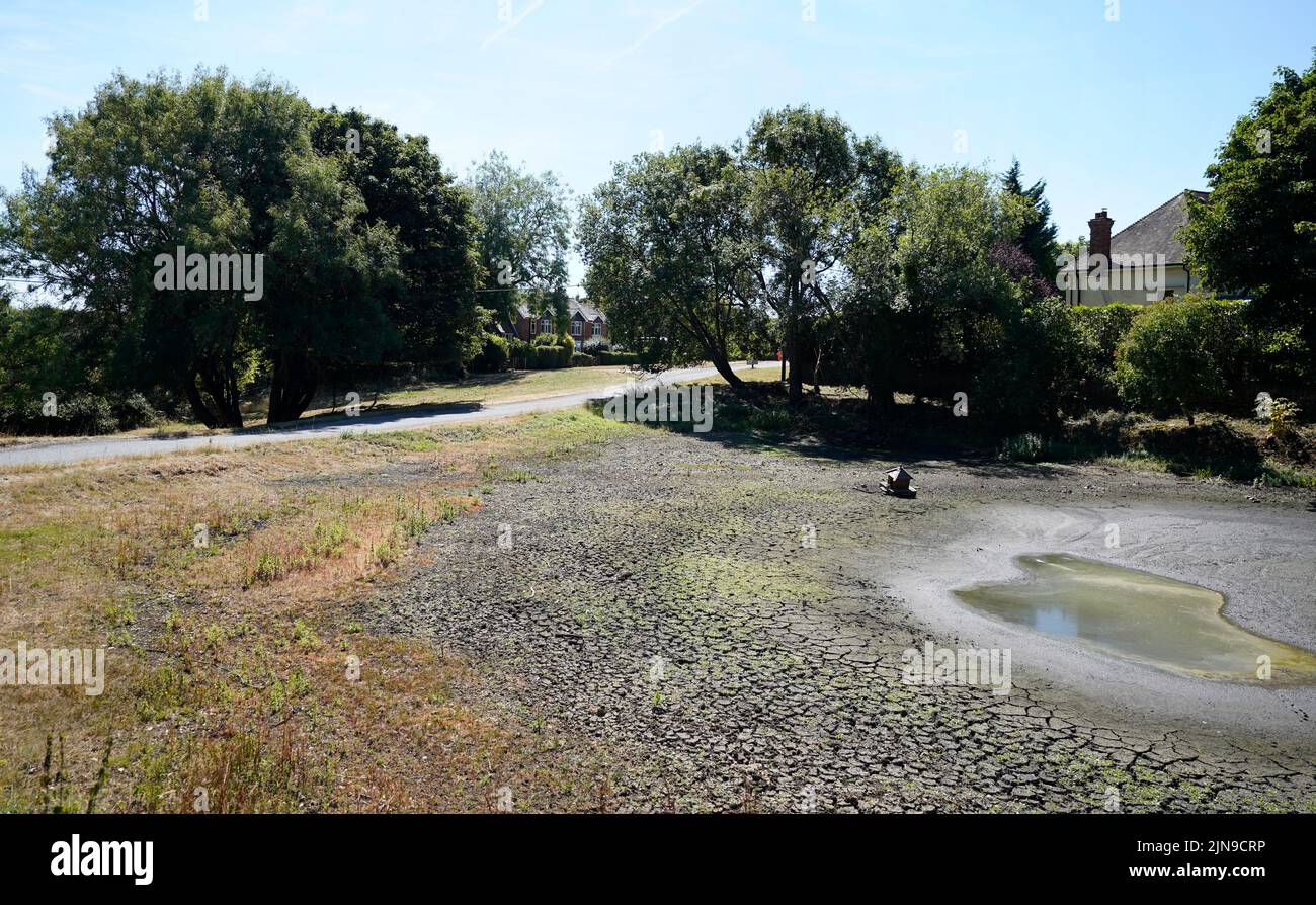 A view of a dried up pond in the village of Northend in Oxfordshire, where Thames Water is pumping water into the supply network following a technical issue at Stokenchurch Reservoir. The Met Office has issued an amber warning for extreme heat covering four days from Thursday to Sunday for parts of England and Wales as a new heatwave looms. Picture date: Wednesday August 10, 2022. Stock Photo