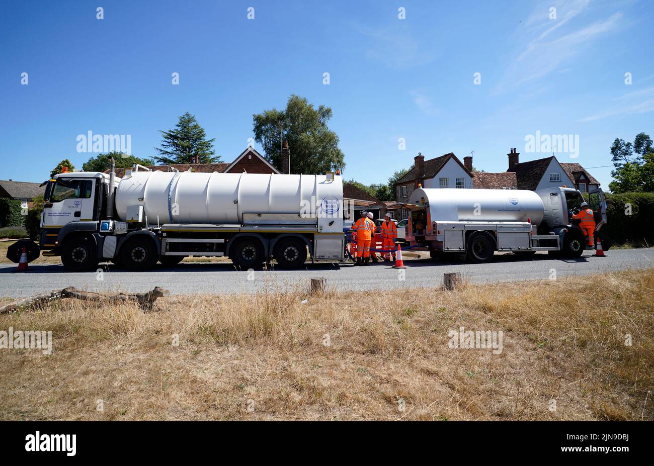 A tanker from Thames Water pumps water into another tanker in the village of Northend in Oxfordshire, where the water company is moving water into the supply network following a technical issue at Stokenchurch Reservoir. The Met Office has issued an amber warning for extreme heat covering four days from Thursday to Sunday for parts of England and Wales as a new heatwave looms. Picture date: Wednesday August 10, 2022. Stock Photo