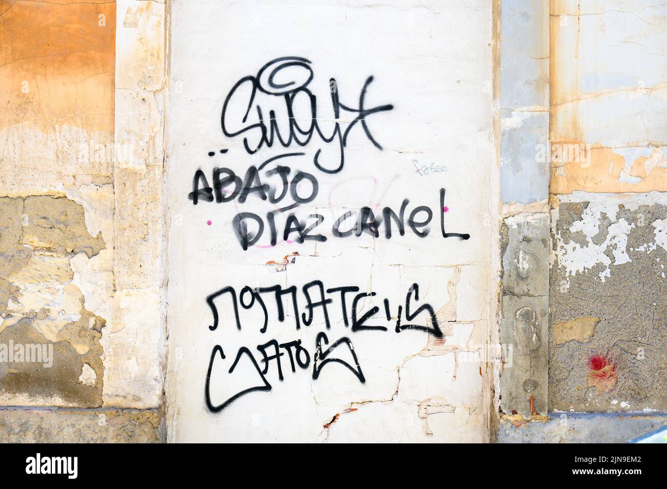 An urban graffiti reading 'Abajo Diaz-Canel'. The political text is painted in a wall in the Spanish city. Stock Photo
