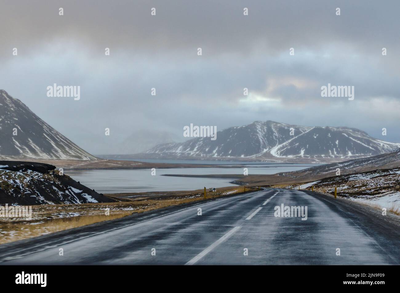 Driving through Iceland on a cold and rainy winter day, every curve in the road reveals views of epic proportions, be they mountains, fjords, or valle Stock Photo