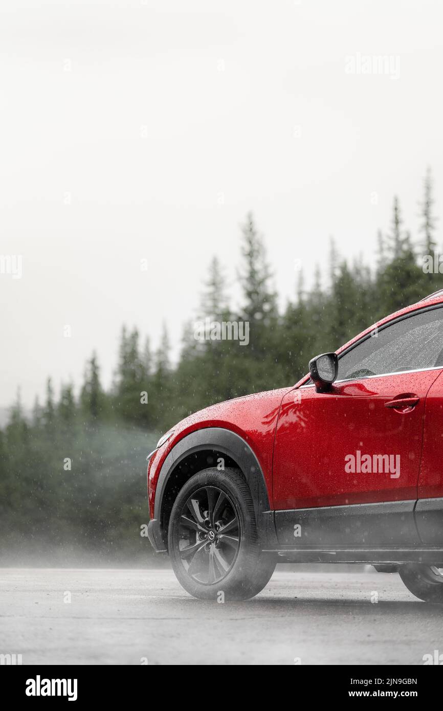 Red Mazda car in rainy day in Mt. Evans, Colorado. Stock Photo