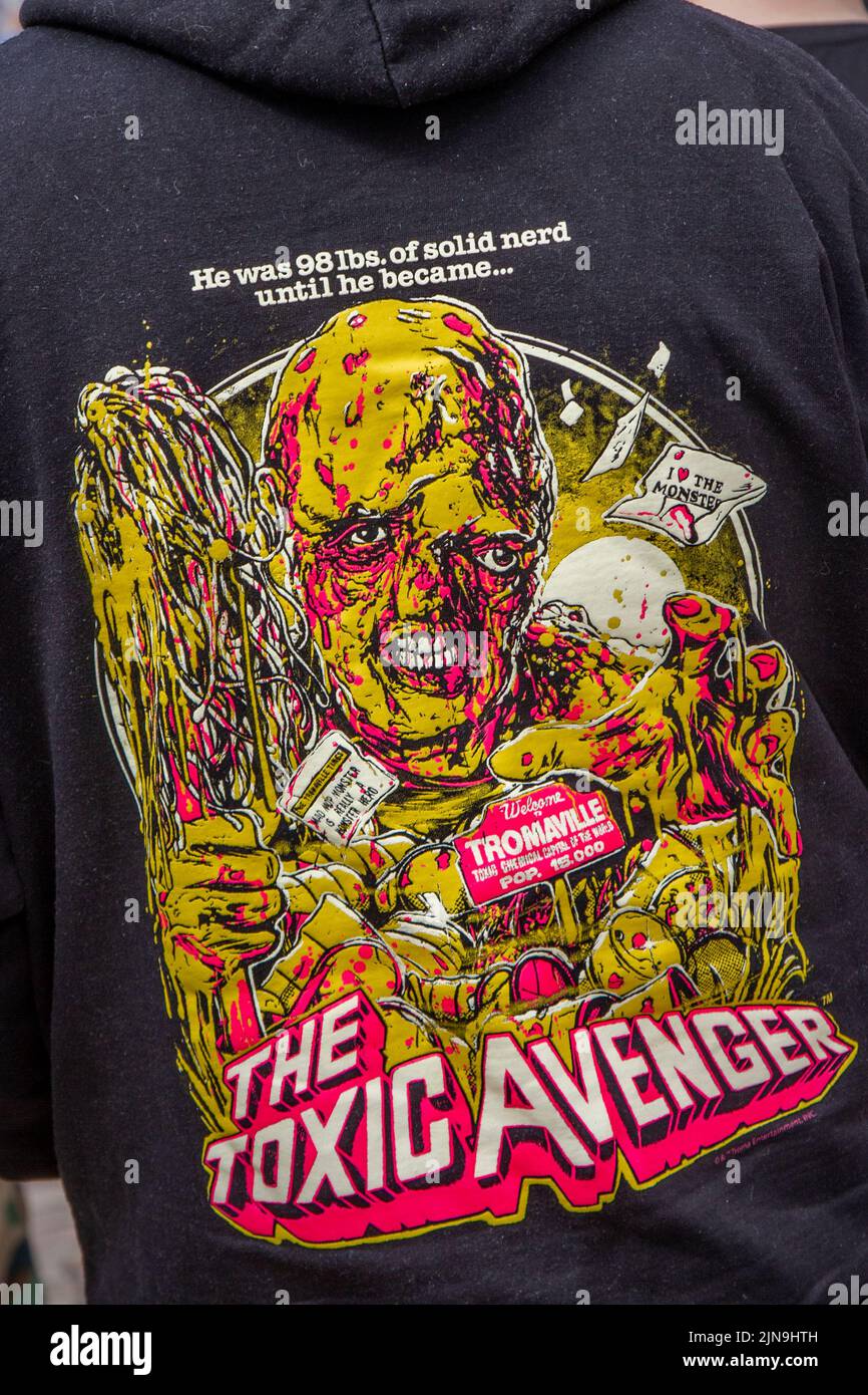 The Toxic Avenger T-Shirt. Punk subculture, ideologies, fashion, with Mohican dyed hairstyles and colouring at the 2022 Punk Rebellion festival at The Winter Gardens, Blackpool, UK. A protest against conventional attitudes and behaviour, a clash of anti-establishment cultures,  mohawks, safety pins and a load of attitude at the seaside town as punks attending the annual Rebellion rock music festival at the Winter Gardens come shoulder to shoulder with traditional holidaymakers. Stock Photo