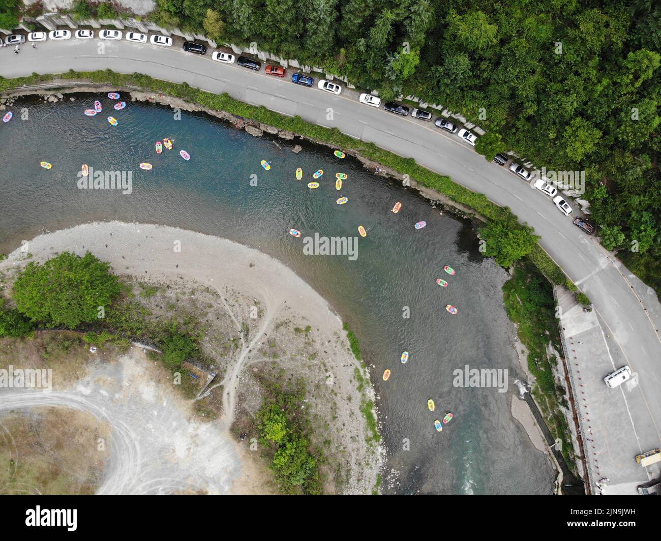 Kaiyang. 10th Aug, 2022. Aerial photo taken on Aug. 10, 2022 shows tourists floating down a river on rafts at the Nanjiang grand canyon scenic area in Kaiyang County, southwest China's Guizhou Province. The scenic area has been a hot spot for tourists to escape the summer heat. Credit: Xiang Dingjie/Xinhua/Alamy Live News Stock Photo