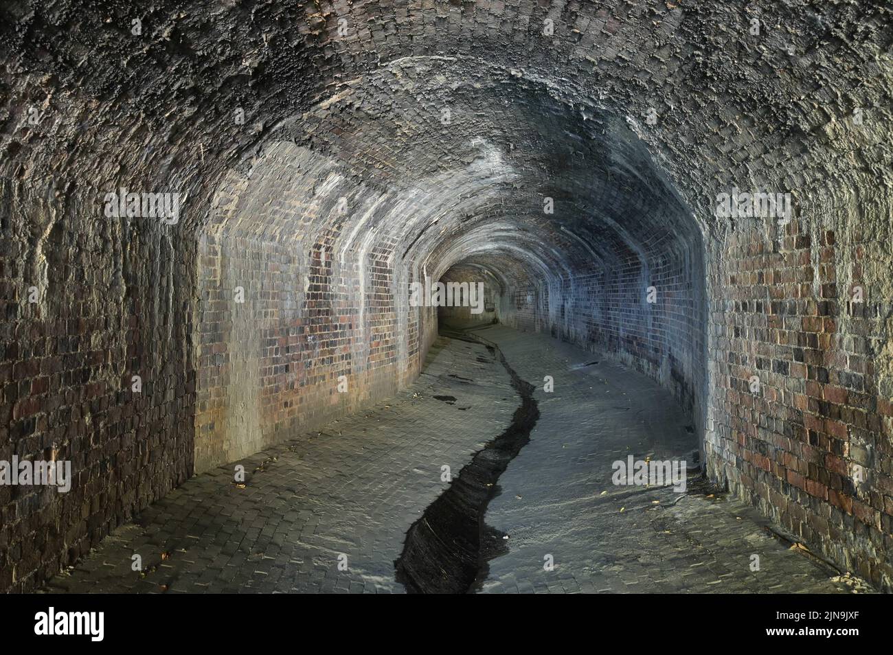Digbeth, Birmingham, England, August 10th 2022. - These Victorian tunnels have been revealed as water levels dropped vastly in Birmingham city centre. The underground culvert was constructed in 1890 to divert the River Rea through Birmingham's industrial centre. Today the culvert acts as a storm drain, during wet weather it rises as high as the ceiling. Despite the searing hot temperatures outside it is very cool underground. Pic by Credit: Sam Holiday/Alamy Live News Stock Photo