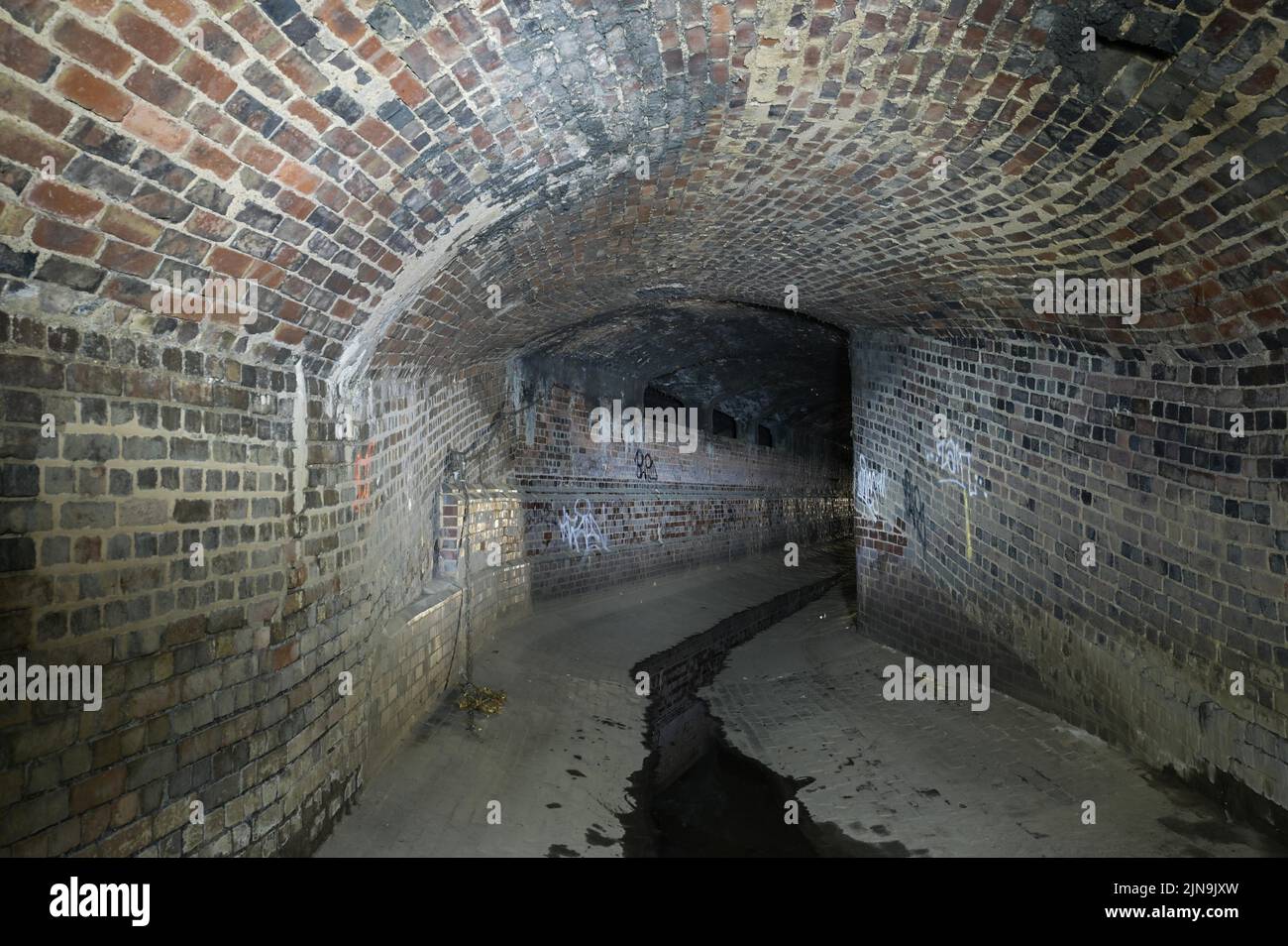Digbeth, Birmingham, England, August 10th 2022. - These Victorian tunnels have been revealed as water levels dropped vastly in Birmingham city centre. The underground culvert was constructed in 1890 to divert the River Rea through Birmingham's industrial centre. Today the culvert acts as a storm drain, during wet weather it rises as high as the ceiling. Despite the searing hot temperatures outside it is very cool underground. Pic by Credit: Sam Holiday/Alamy Live News Stock Photo