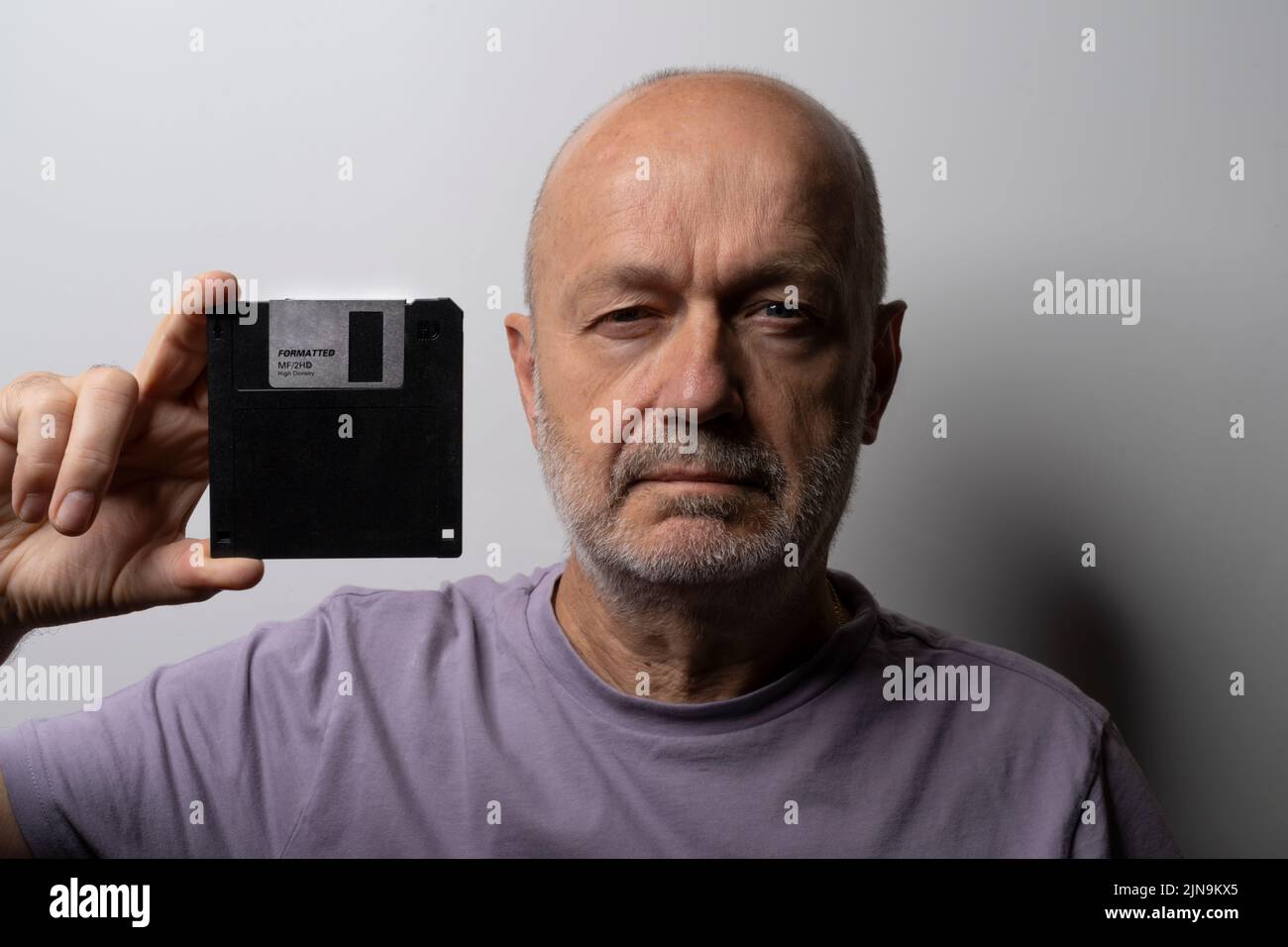 a man with an old floppy disk in his hand Stock Photo