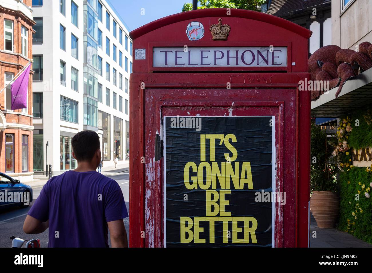 London, UK.  10 August 2022.  A man walks past a telephone box in Mayfair which carries a promotional message “It’s Gonna Be Better”.  Given the UK’s current economic woes, rising inflation rate, rise in the base rate, cost of living crisis and drought conditions, some might see this as a hope for the future.  Credit: Stephen Chung / Alamy Live News Stock Photo