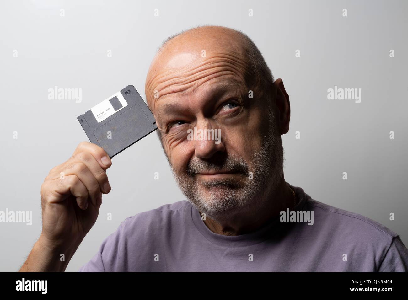 a man with an old floppy disk in his hand Stock Photo