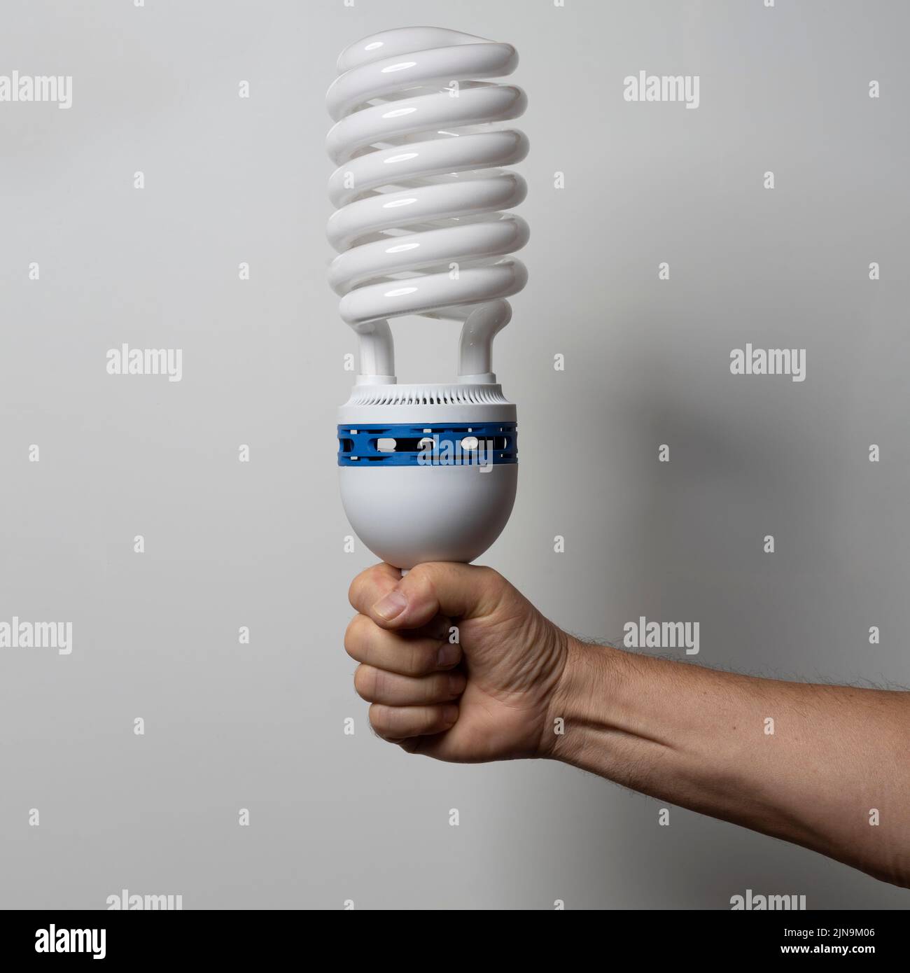 a huge lowenergy electronic light bulb in his hand Stock Photo Alamy